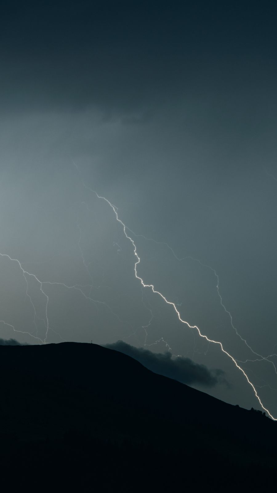 Lightning striking a dark ridge